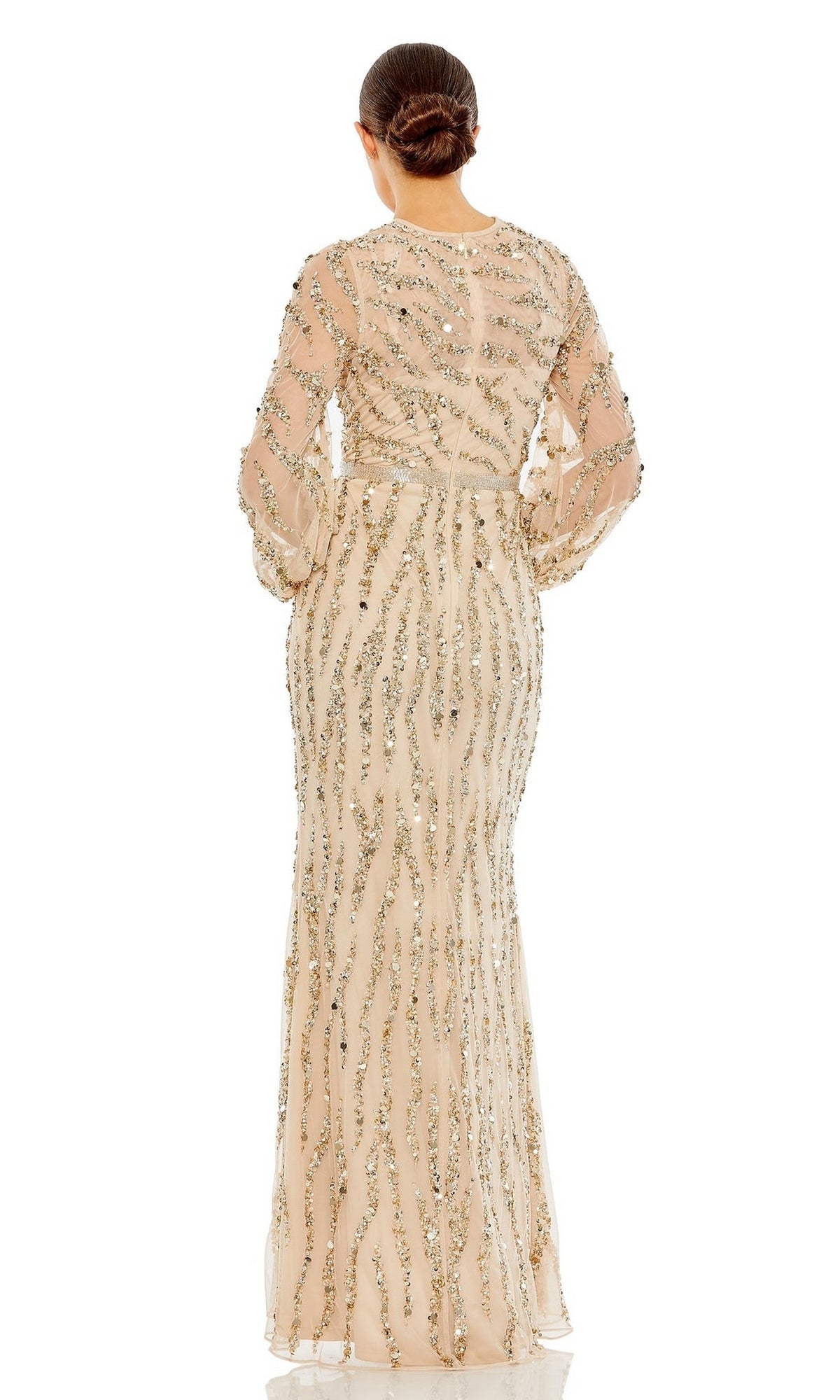 A person stands facing away, wearing the Mac Duggal 93789 Long Sleeve Gold Formal Dress with metallic sequin embellishments and their hair in a low bun.